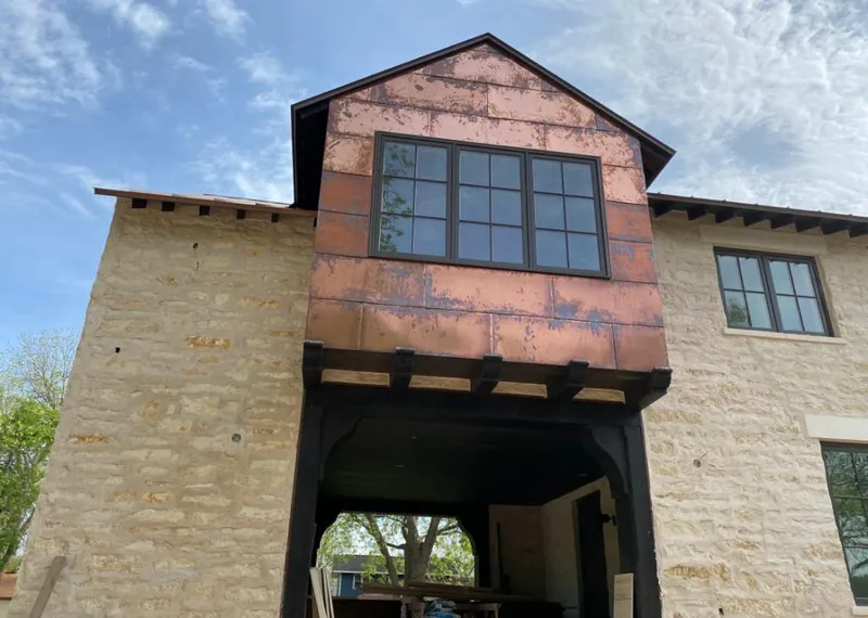 Copper metal panel facade on a stone building for Roof Repair in Laredo