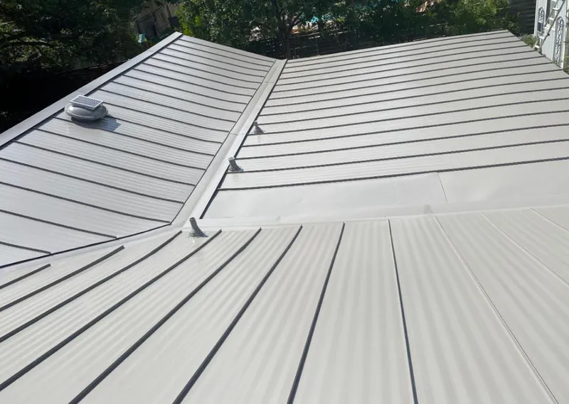 Solar attic fan installed on a metal roof for Roof Ventilation in Laredo
